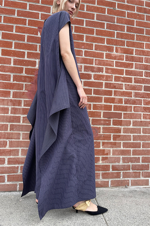 Long cotton stipe sleeveless jumpsuit. panels on the hips that can be left loose or tied. Wide legs. keyhole back. single button closure at the neck. Dusan jumpsuit. Dusan paneled jumpsuit. Versatile jumpsuit Dusan. Navy Pinstripe jumpsuit. Dusan Des Kohan. Dusan West Hollywood. Dusan Los Angeles. Dress up or casual Jump suit. Great tailoring. 