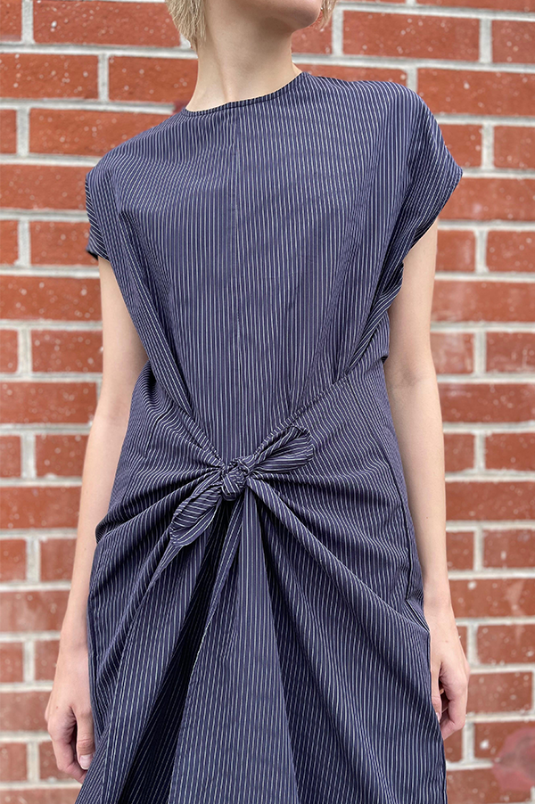 Long cotton stipe sleeveless jumpsuit. panels on the hips that can be left loose or tied. Wide legs. keyhole back. single button closure at the neck. Dusan jumpsuit. Dusan paneled jumpsuit. Versatile jumpsuit Dusan. Navy Pinstripe jumpsuit. Dusan Des Kohan. Dusan West Hollywood. Dusan Los Angeles. Dress up or casual Jump suit. Great tailoring. 