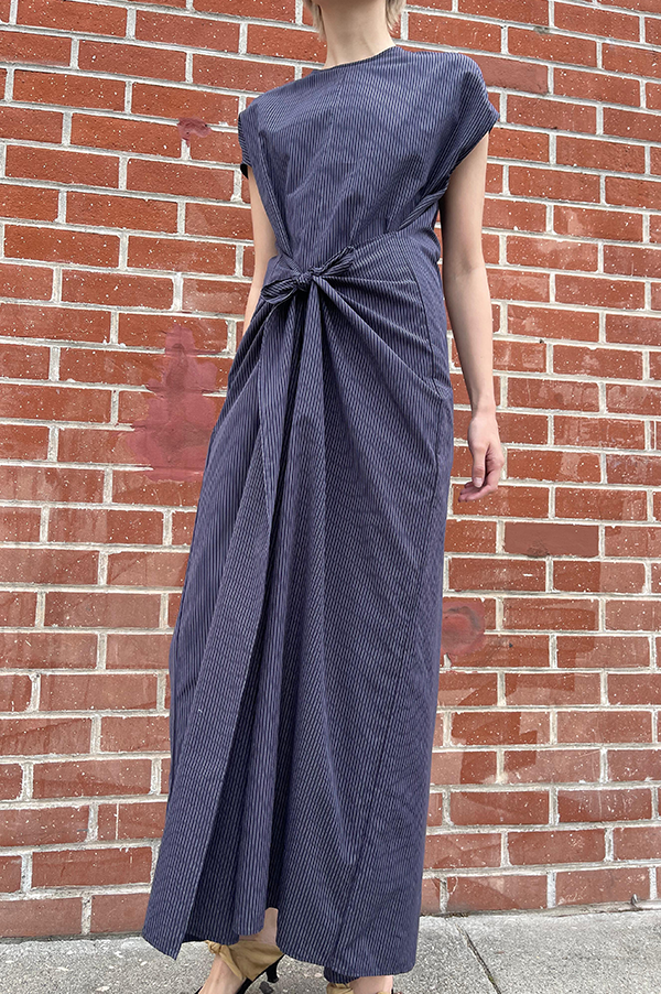Long cotton stipe sleeveless jumpsuit. panels on the hips that can be left loose or tied. Wide legs. keyhole back. single button closure at the neck. Dusan jumpsuit. Dusan paneled jumpsuit. Versatile jumpsuit Dusan. Navy Pinstripe jumpsuit. Dusan Des Kohan. Dusan West Hollywood. Dusan Los Angeles. Dress up or casual Jump suit. Great tailoring. 