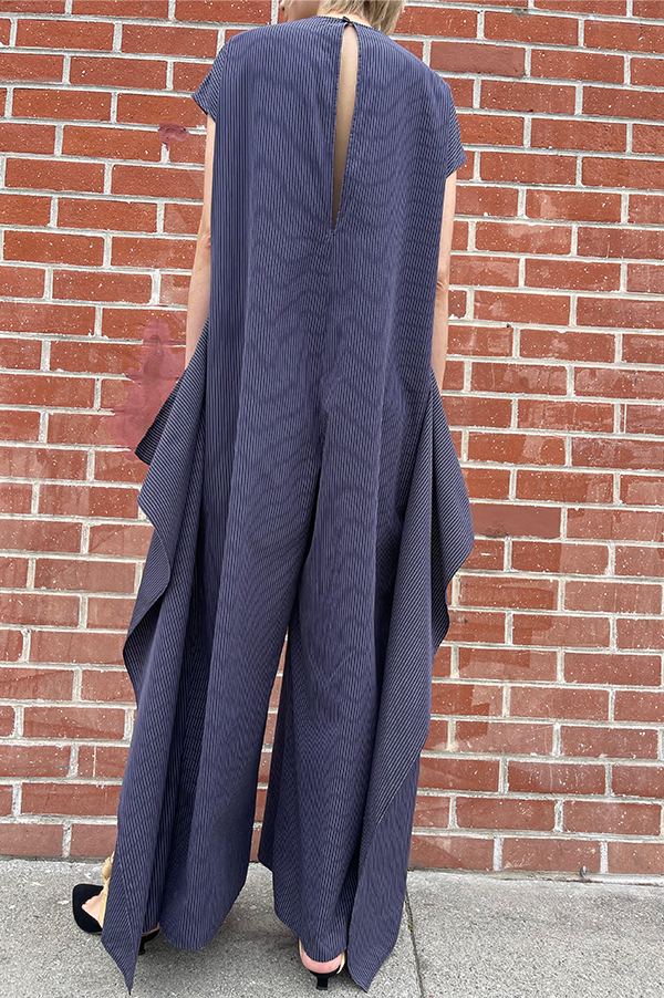 Long cotton stipe sleeveless jumpsuit. panels on the hips that can be left loose or tied. Wide legs. keyhole back. single button closure at the neck. Dusan jumpsuit. Dusan paneled jumpsuit. Versatile jumpsuit Dusan. Navy Pinstripe jumpsuit. Dusan Des Kohan. Dusan West Hollywood. Dusan Los Angeles. Dress up or casual Jump suit. Great tailoring. 