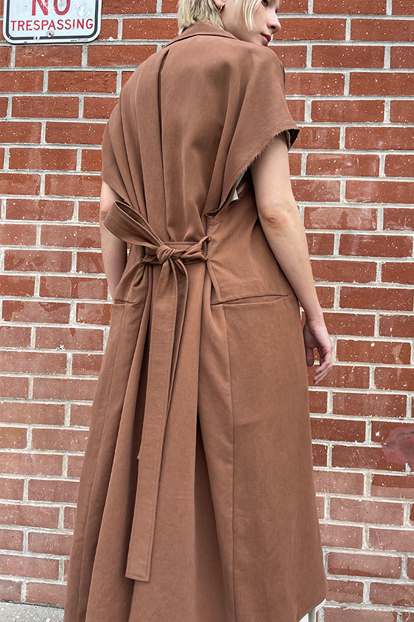 Terracotta. Dusan Terracotta. Dusan Heavy satin relaxed fit trench coat w/ tie. Dusan slash pockets at hips, high slit in the back, raw edges around armholes. Dusan sleeveless trench coat. Dusan Sleeveless Trench terracotta. Dusan sleeveless trench rich chocolate. Dusan Los Angeles. Dusan Des Kohan. Dusan Des Kohan Exclusive Trench Coat. Des Kohan West Hollywood. Dusan West Hollywood. 